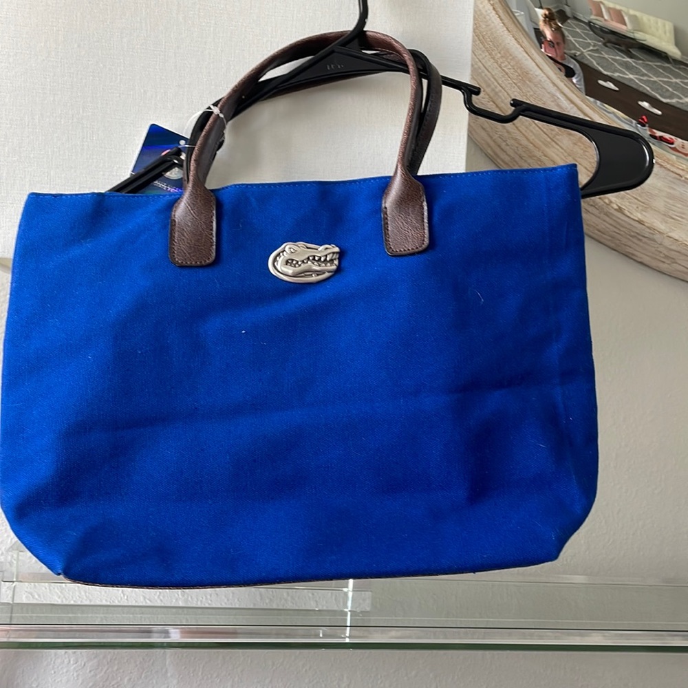 Blue Bag With Metal Logo and Brown Leather Handle